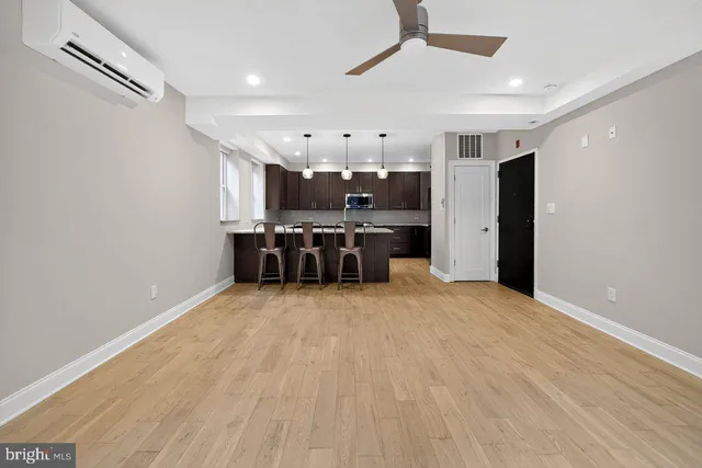 a view of a kitchen with a sink stainless steel appliances and cabinets