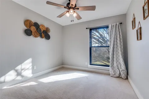 a view of room with window and ceiling fan
