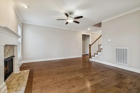 a view of an empty room and a kitchen