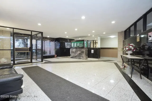 a large white kitchen with a large window and furniture