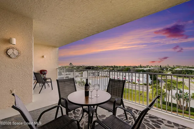 a view of a balcony with a table and chairs
