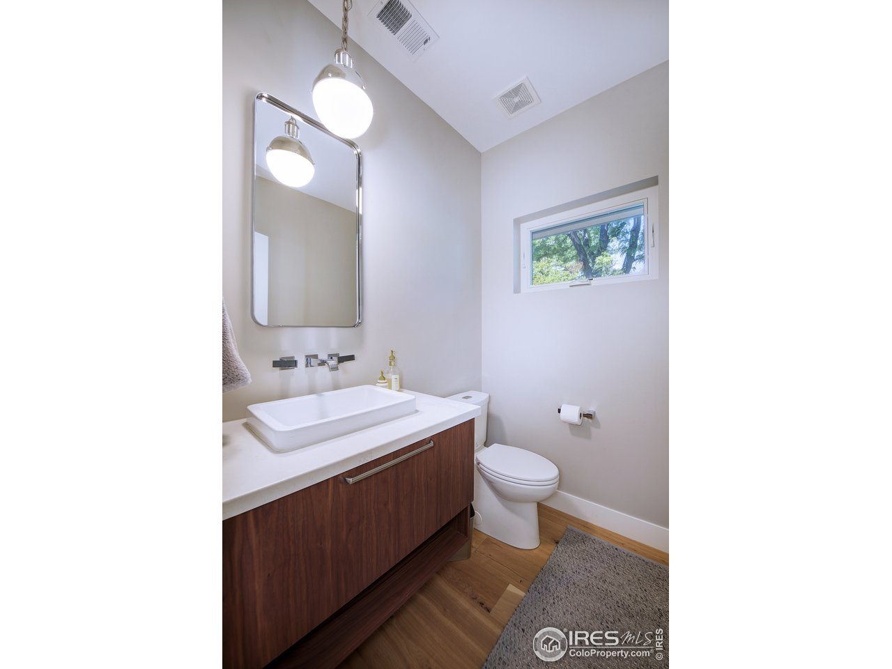 2930 18th Street Boulder, CO 80304 - Photo 16 of 40 a bathroom with a sink a toilet and a mirror