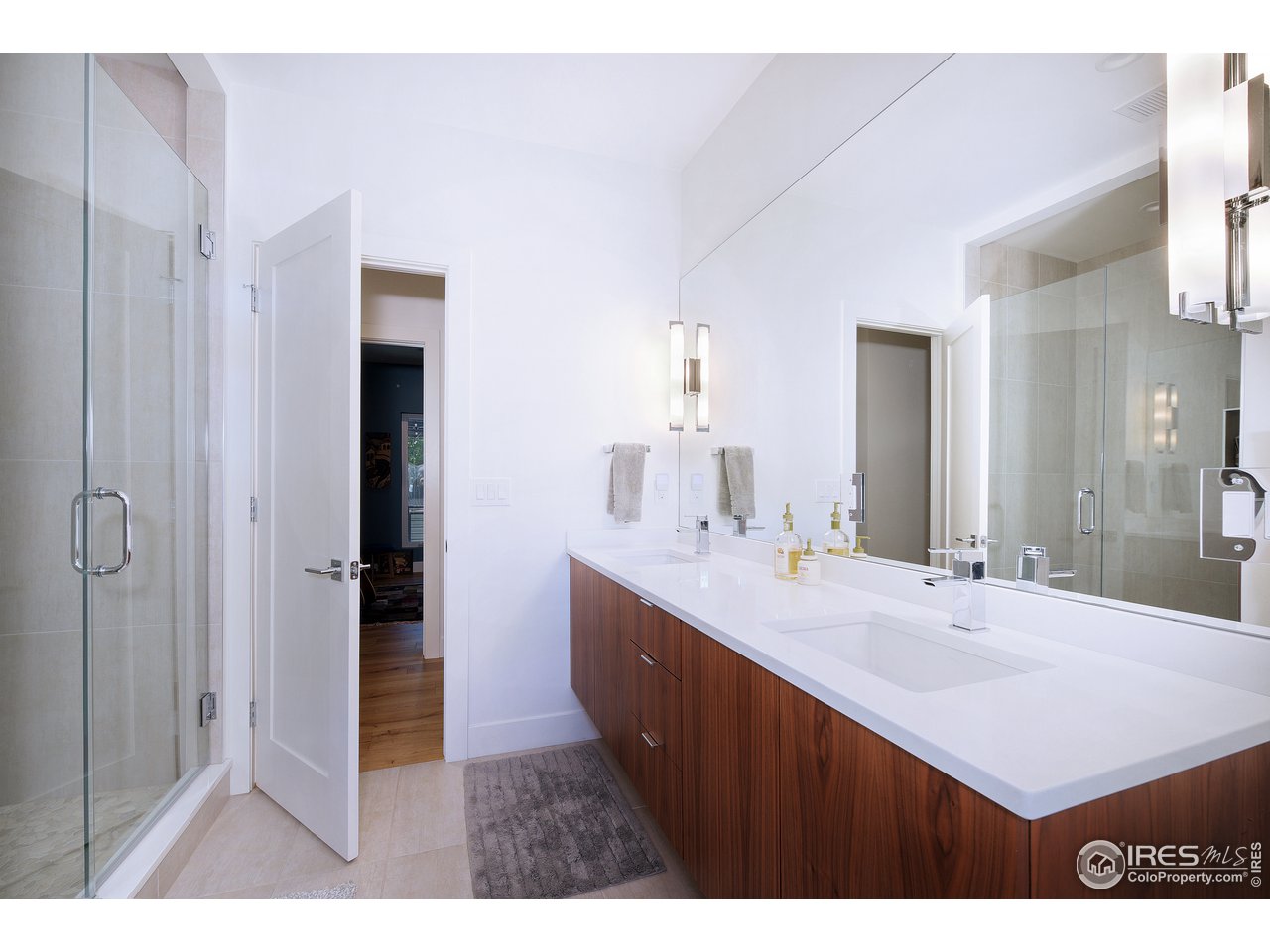 2930 18th Street Boulder, CO 80304 - Photo 18 of 40 a bathroom with a sink a mirror and a shower