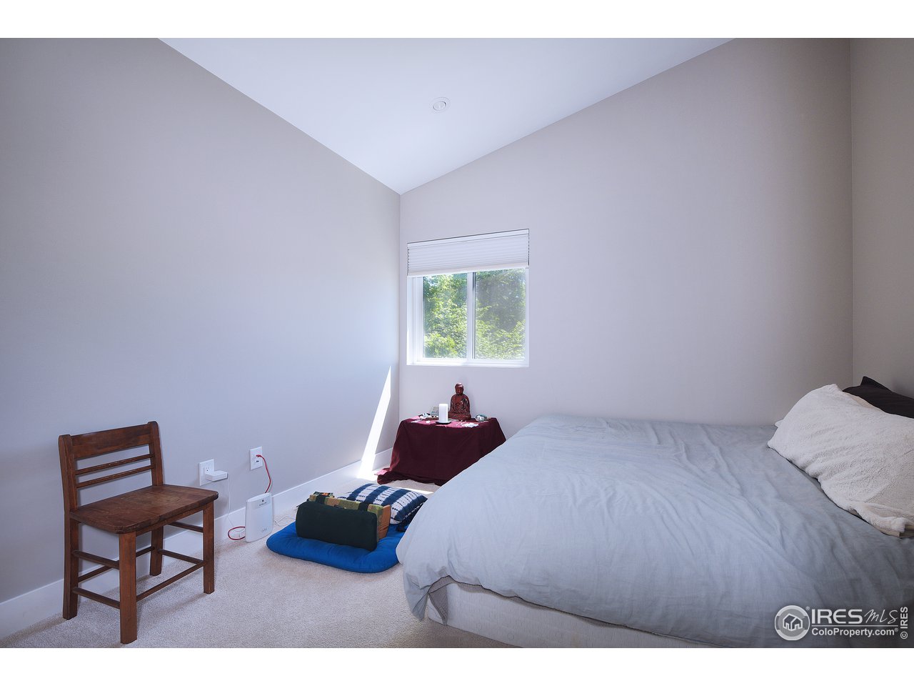 2930 18th Street Boulder, CO 80304 - Photo 27 of 40 a bedroom with a bed window and a chair