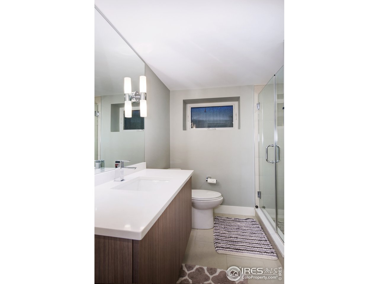 2930 18th Street Boulder, CO 80304 - Photo 32 of 40 a bathroom with a sink a toilet and mirror