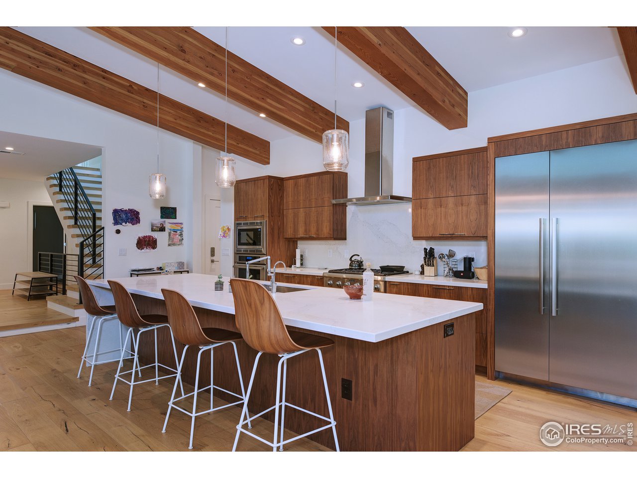 2930 18th Street Boulder, CO 80304 - Photo 8 of 40 a kitchen with a dining table cabinets stainless steel appliances and a counter top space