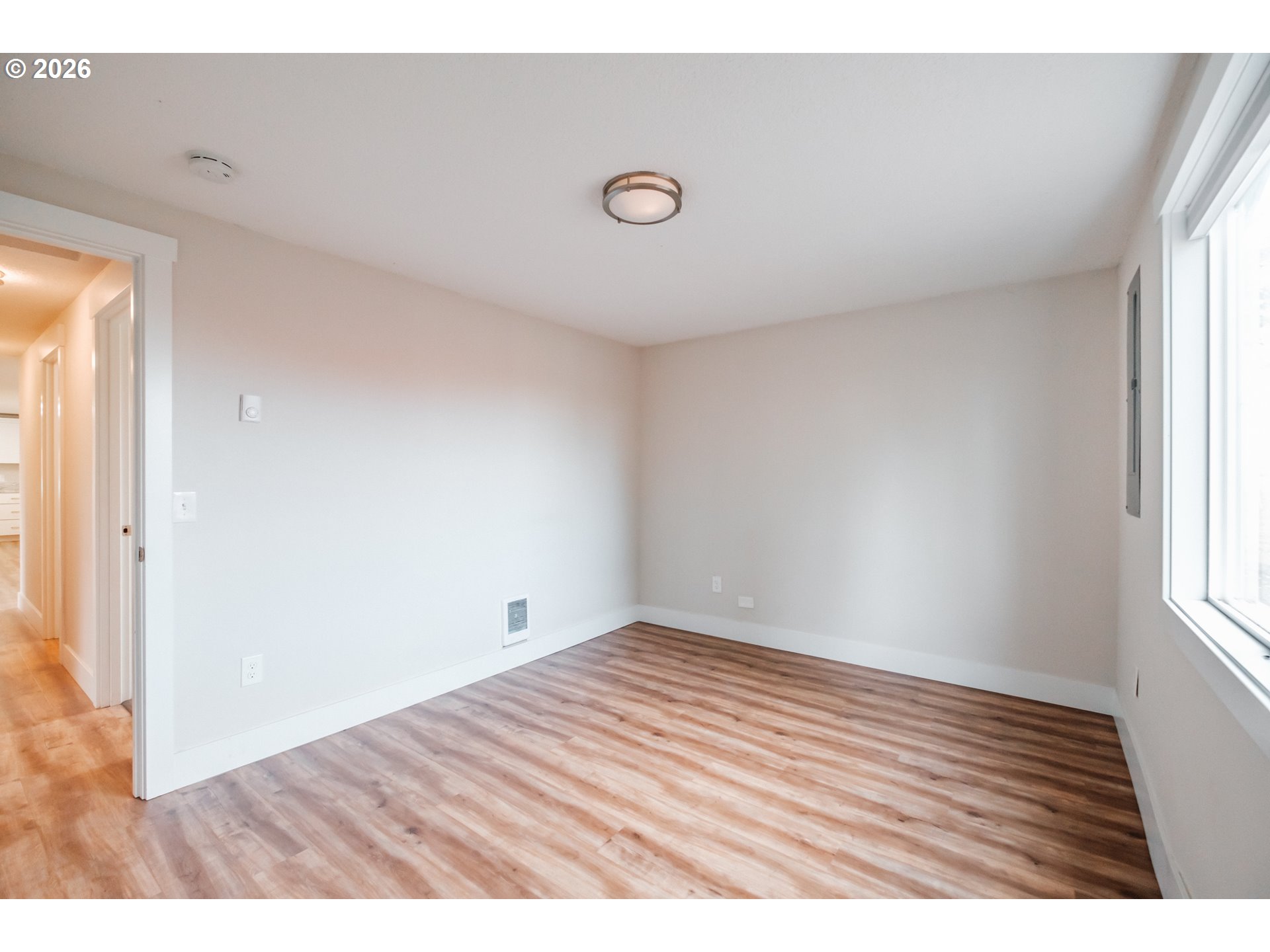 10471 Wagon Road Northeast Mount Angel, OR 97362 - Photo 22 of 48 an empty room with wooden floor and windows