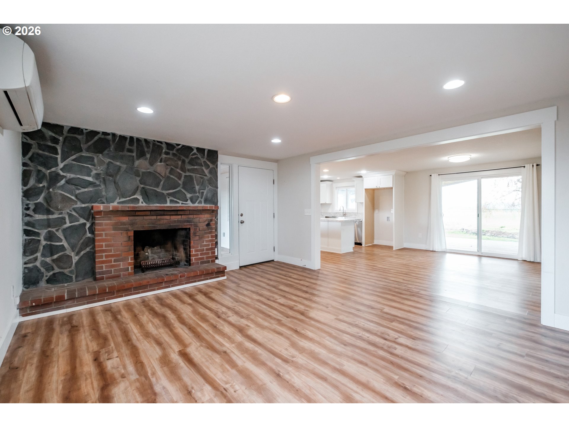 10471 Wagon Road Northeast Mount Angel, OR 97362 - Photo 5 of 48 a view of empty room with wooden floor and fireplace