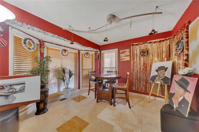 a living room with furniture a flat screen tv and a large window