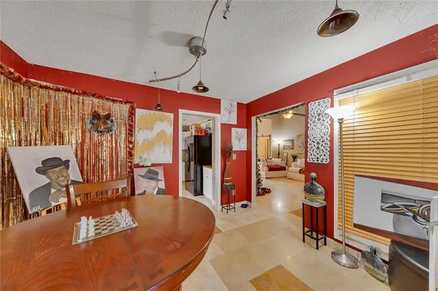 a living room with furniture a flat screen tv and large window
