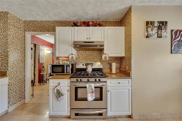 a kitchen with a stove and cabinets