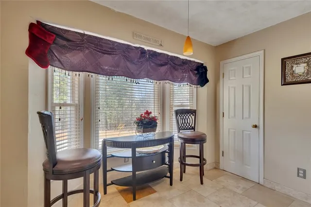 a view of a dining room with furniture and a window