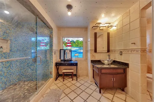 a bathroom with a sink a toilet and mirror