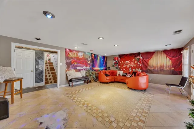 a very nice looking room with a large window and furniture