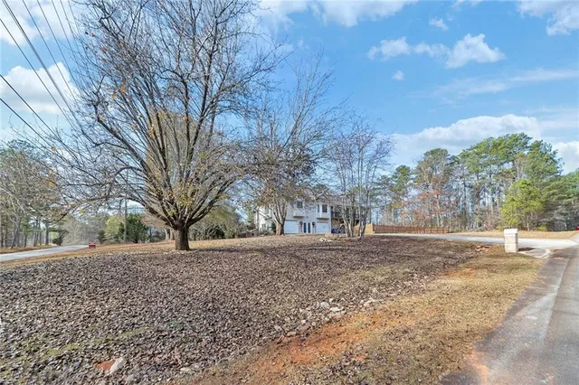 a backyard of a house with large trees
