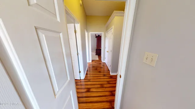 a front view of house with yard and trees in the background