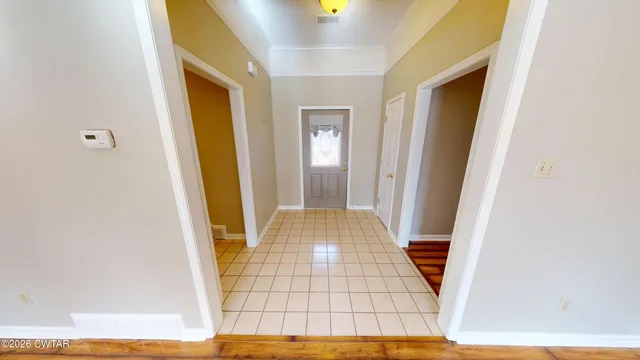 a room with bed and wooden floor