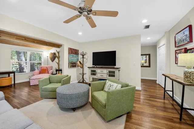 a living room with furniture and wooden floor