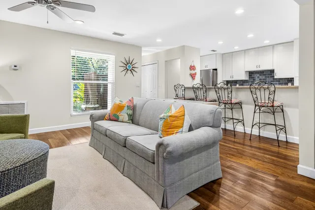 a living room with furniture and wooden floor