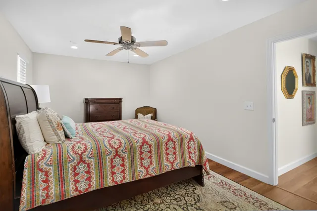 a bathroom with a granite countertop toilet sink and mirror
