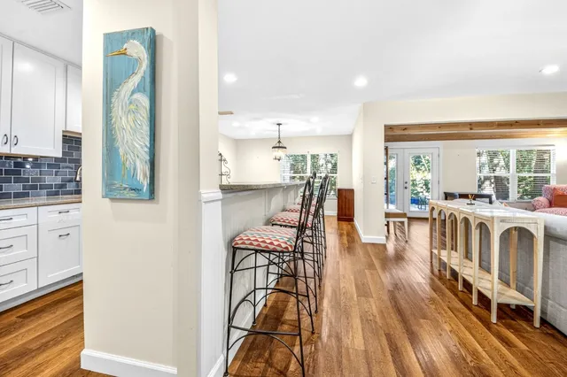 a view of a kitchen with dining room and wooden floor