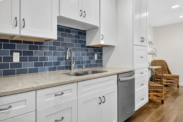 a kitchen with granite countertop a stove and a sink