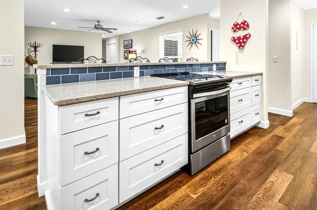 a dining room with wooden floor a chandelier a wooden table and chairs