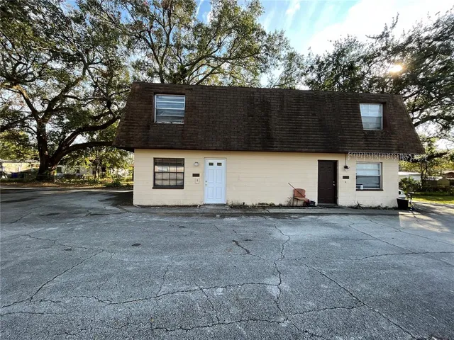a view of a parking space in front of a house