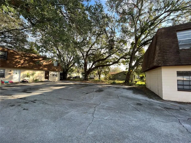 a view of a street with large trees