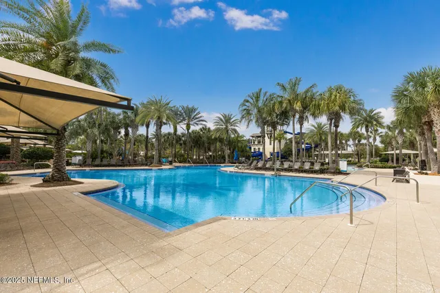 a view of a patio with couches table and chairs with plants