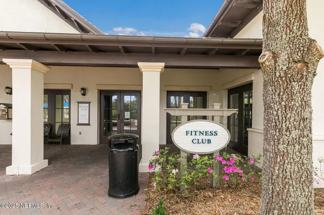 a view of a swimming pool with a lounge chair and palm trees