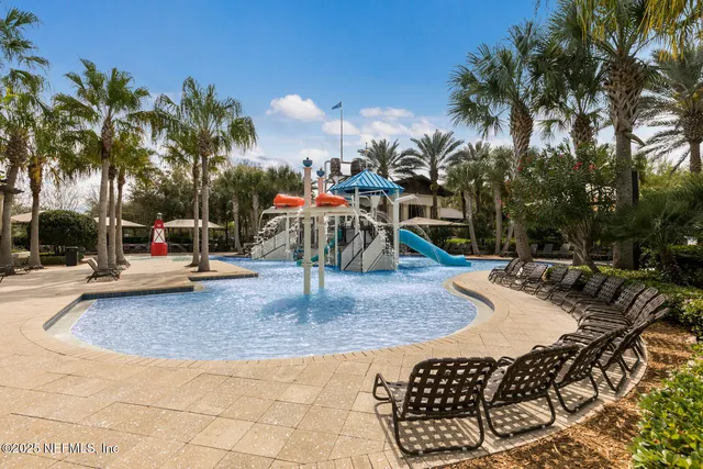 a living room with furniture and large windows