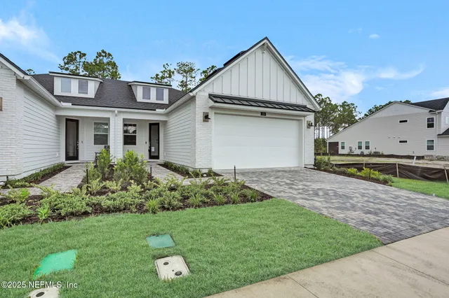 a view of a house with a yard and plants