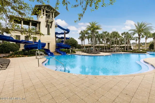 a view of a swimming pool with a table and chairs