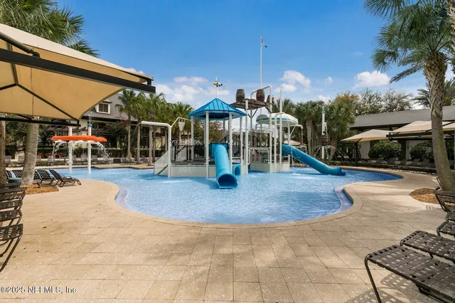 a view of swimming pool with sitting area and tub