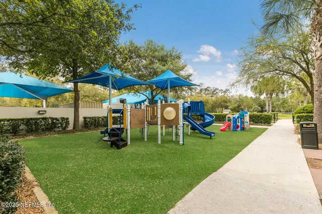 a view of swimming pool with outdoor seating and plants