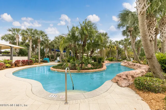 a view of yard with swimming pool and green space