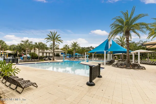 a view of swimming pool with outdoor seating and a garden