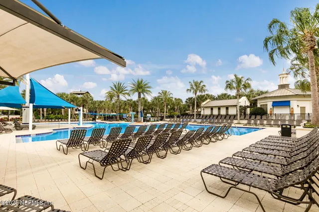 a swimming pool with outdoor seating