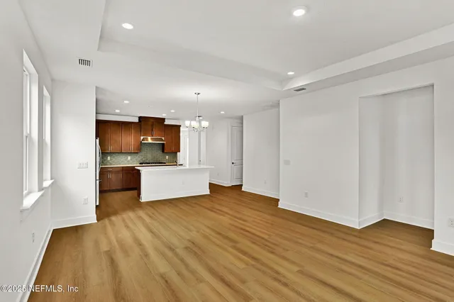 a view of a kitchen with a sink and a refrigerator