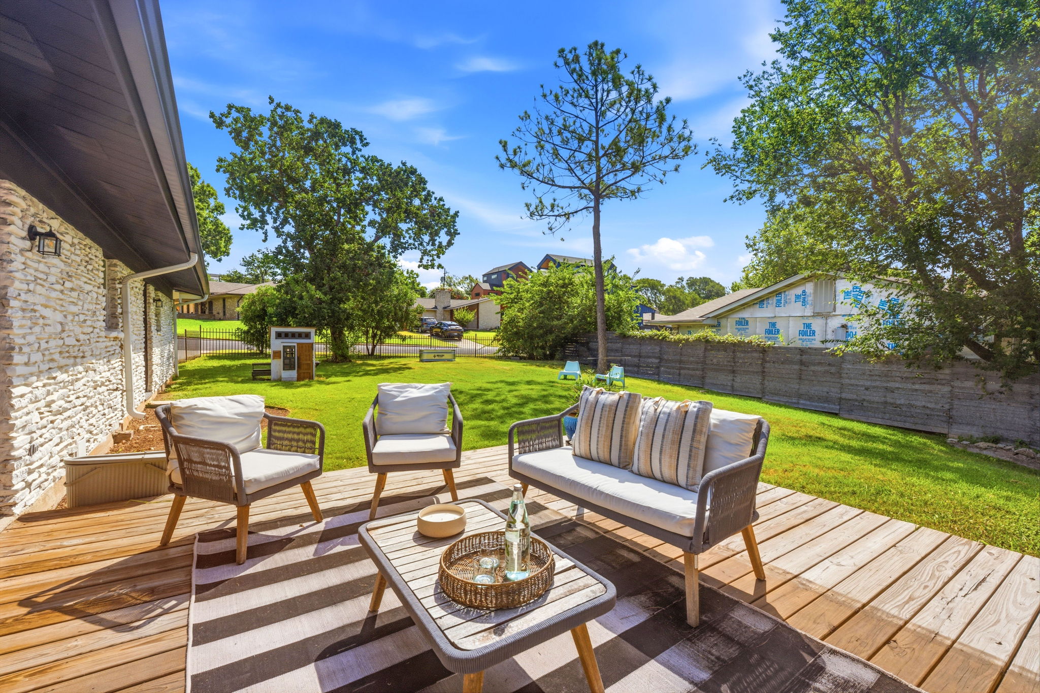 4403 Elmsgrove Drive Austin, TX 78721 - Photo 14 of 38 A spacious backyard deck extends the living space outdoors, perfect for tranquil relaxation or lively entertaining.