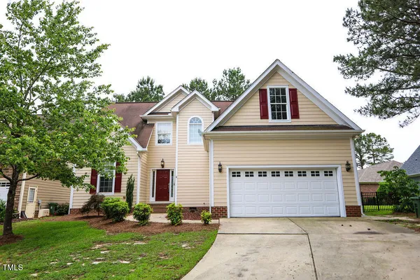 a front view of a house with a yard and garage