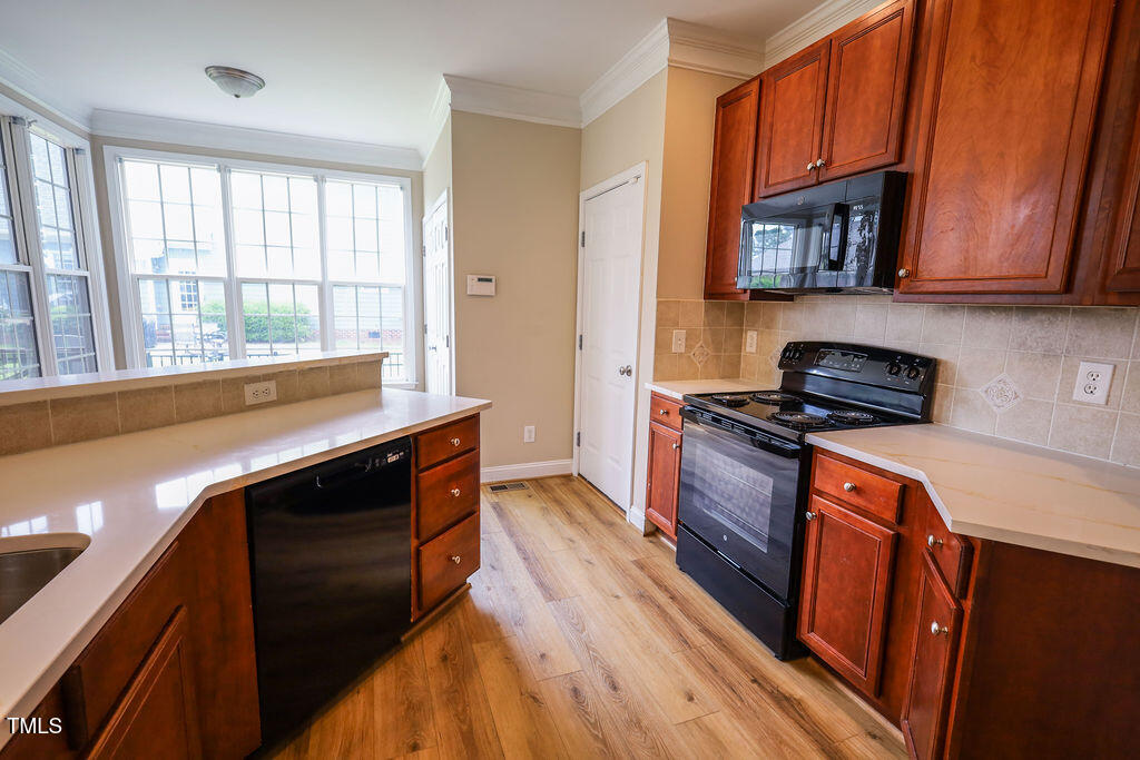 10 London Way Spring Lake, NC 28390 - Photo 11 of 26 a kitchen with stainless steel appliances granite countertop a stove a sink and a refrigerator