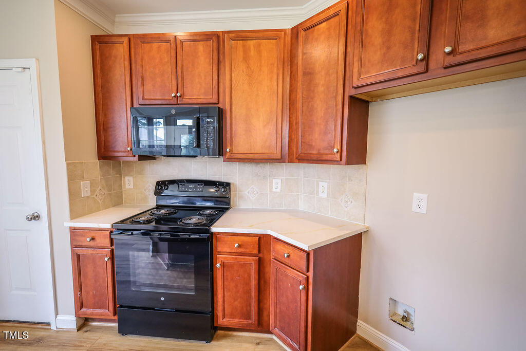 10 London Way Spring Lake, NC 28390 - Photo 12 of 26 a kitchen with stainless steel appliances granite countertop a stove and a microwave