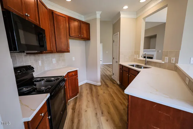 a kitchen with stainless steel appliances a stove sink microwave and cabinets