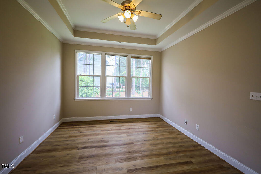 10 London Way Spring Lake, NC 28390 - Photo 15 of 26 a view of an empty room with wooden floor and a window