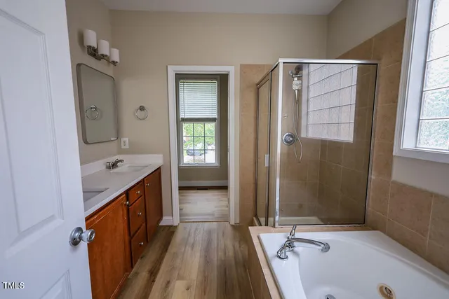 a bathroom with a tub and a shower