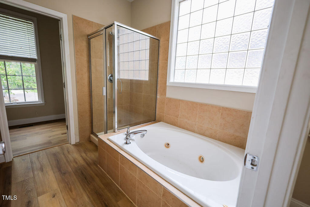 10 London Way Spring Lake, NC 28390 - Photo 17 of 26 a bathroom with a tub and a shower