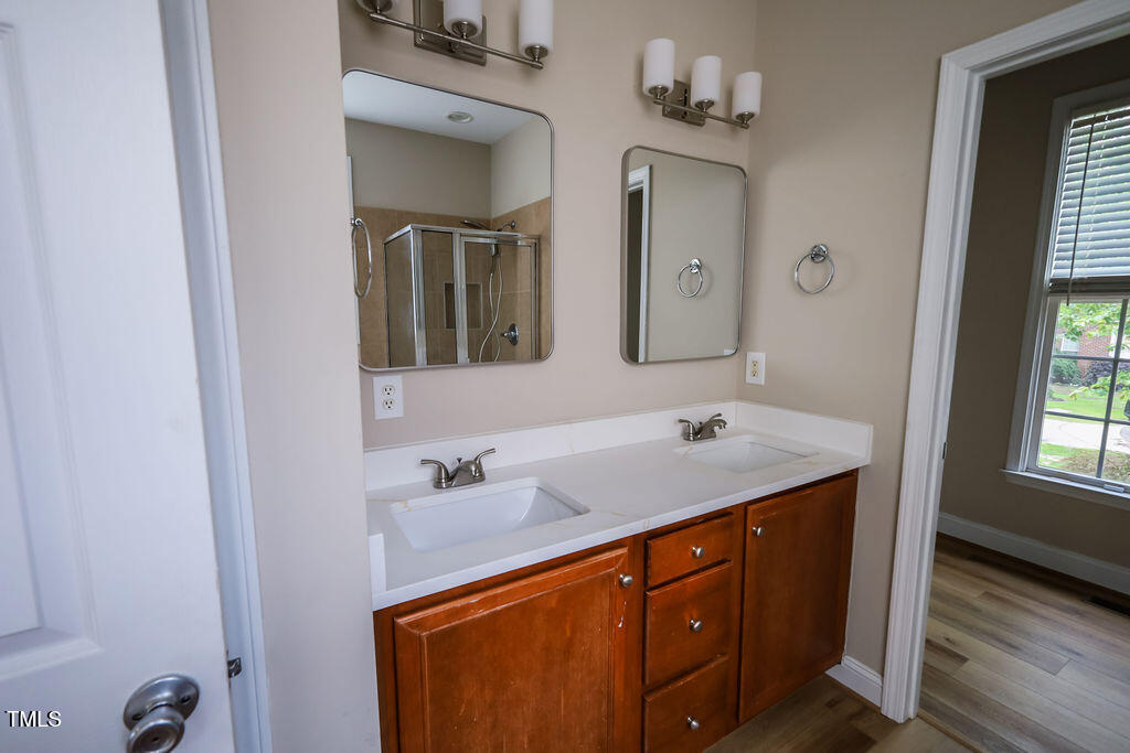 10 London Way Spring Lake, NC 28390 - Photo 18 of 26 a bathroom with a sink a vanity and a mirror