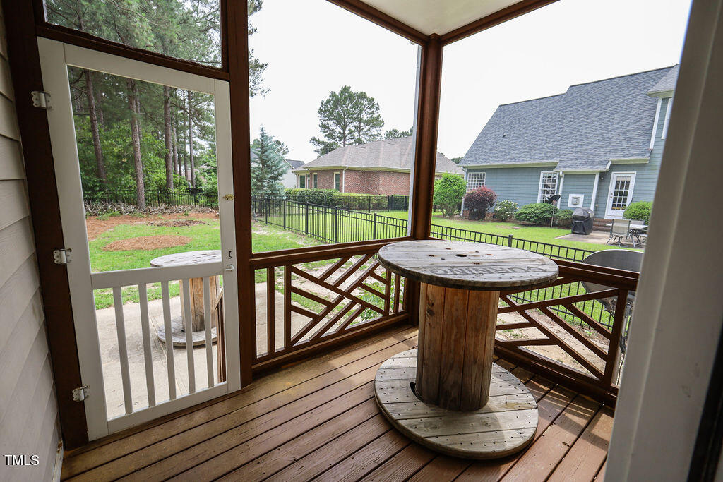 10 London Way Spring Lake, NC 28390 - Photo 24 of 26 a view of a patio with a table chairs and a grill